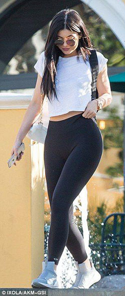 Kylie Jenner flashes her midriff in white cropped T-shirt and black leggings: White Top  