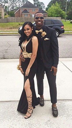 Look how they shine together, her in a black dress with a high slit, and him in a classic suit with gold details: party outfits,  Backless dress,  Prom Dresses,  Black Couple Homecoming Dresses  