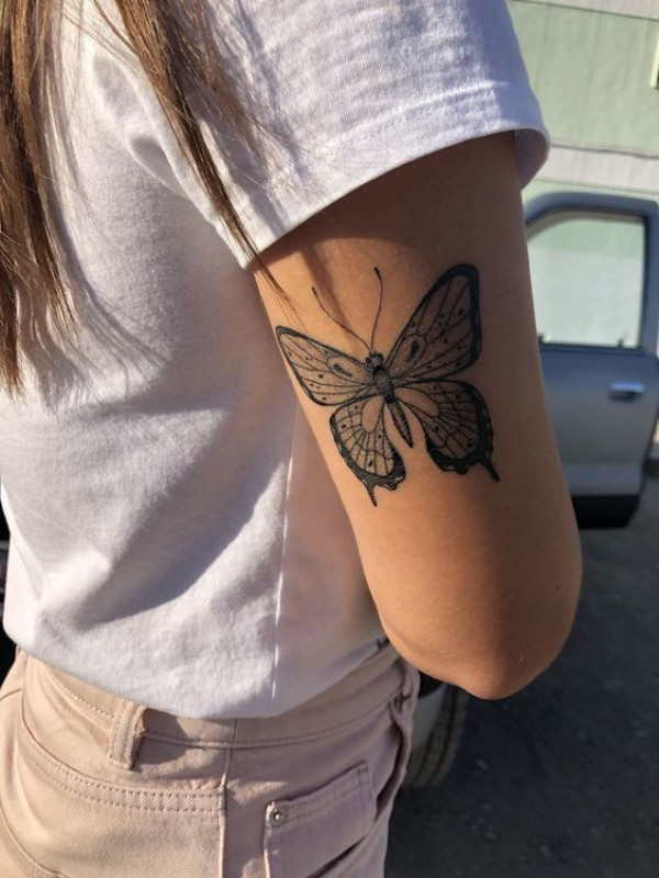 Simple black and grey butterfly tattoo on the left upper arm   Tattoogridnet