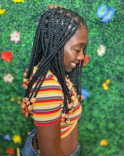 Those jet black knotless strands are channeling some serious bohemian vibes with that bead bliss: Box braids  
