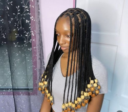 Check out those shimmering knotless braids, with a hint of golden wood for that extra pop. Pretty cool, huh?: 