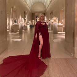 Billie Eilish looks absolutely breathtaking in that flowing crimson dress: 