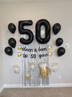 Celebrating a frothy fifty with black balloons and golden brews. It's a fest where every sip feels like a toast: 