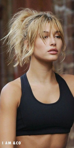 Going from gym to glam with a casual bun and bold bangs is such a vibe!: 