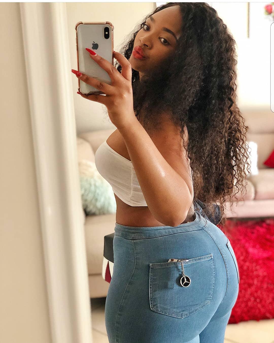 The girl wearing white top with denim pant is a symbol of today’s modern and sexy African diva.: 