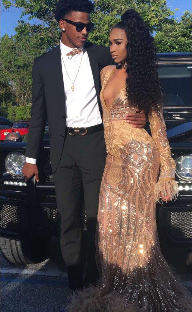 Shine together, her in an ornate golden gown, him in a suit as dark as night!: Black Couple Homecoming Dresses  