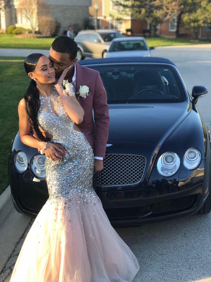 They bring the glam, her in a dress that outshines the stars, him in a suit that's all class!: party outfits,  Backless dress,  Sleeveless shirt,  Black Couple Homecoming Dresses  