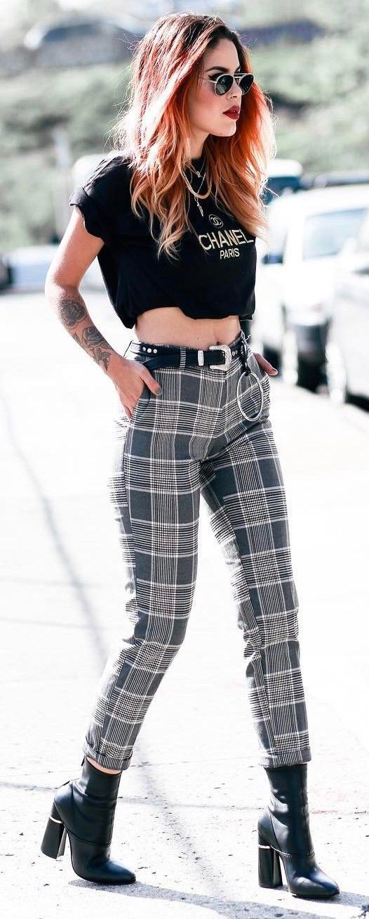 Woman with checkered trousers in black and white before Gucci fashion show,  Milan Fashion Week street style on September 21 Stock Photo - Alamy