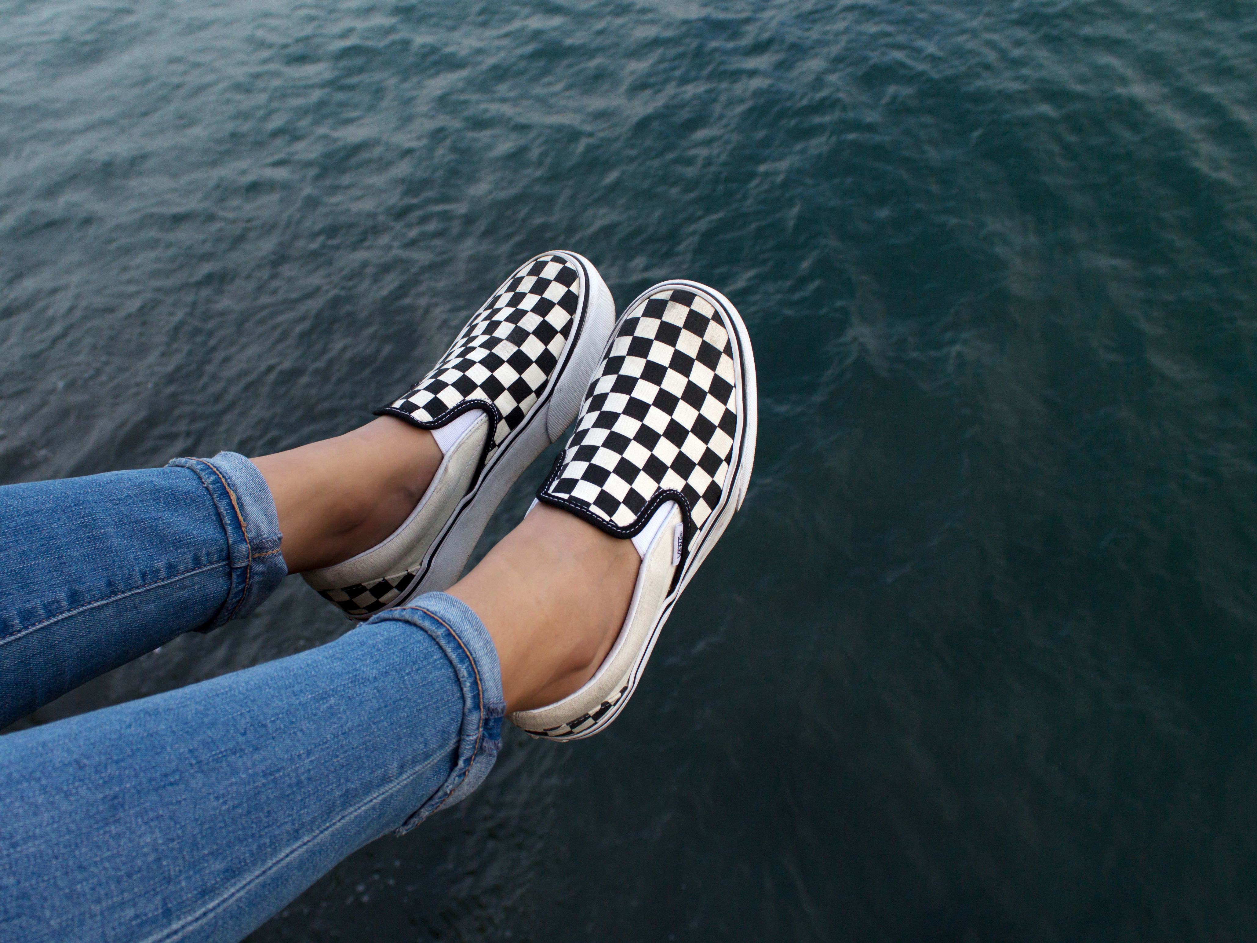 checkerboard slip on vans on feet