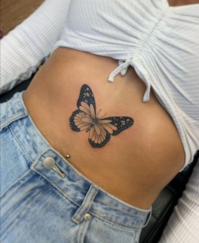 Microrealistic butterfly tattoo on the rib