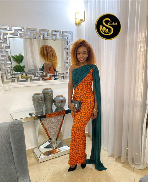 Feel the Warmth of a Tropical Sunset in an Ankara Gown Mixing Fiery Oranges and Cool Greens: 