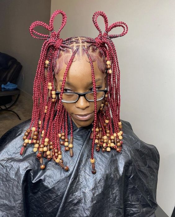 Feeling bold with those braids in berry red, all beaded with nature's best: headgear,  visual perception,  Fashion accessory,  Costume design,  headgear,  visual perception,  headgear,  visual perception  