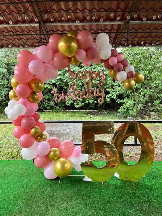 Have you checked out the amazing decorations at 'Golden Milestone Under a Pink Balloon Archway'?: balloon,  personal identification number,  party decoration,  party supply,  Lapel pin  