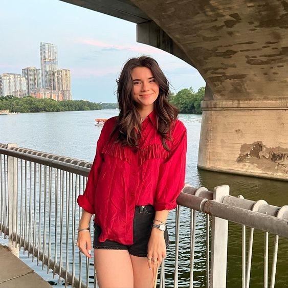 Her bold red top is just as striking as the view, so sexy!: brett cooper hot,  the comments section with brett cooper,  comments section,  the daily wire,  body of water,  brett cooper  