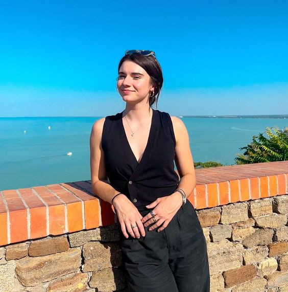 Feeling so chill by the sea in her sleeveless black top, perfectly matching the deep blue waters!: brett cooper hungary,  - young america's foundation,  terror on the prairie,  comments section,  the daily wire,  brett cooper  
